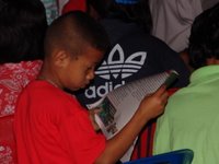 Thai boy reading evangelistic magazine